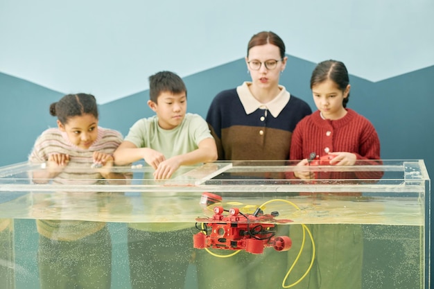 A K-12 classroom where students are engaged in a hands-on STEM activity, such as building a model bridge or conducting a science experiment.