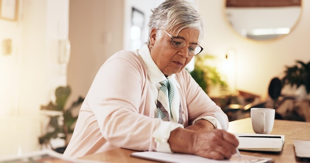 A person confidently signing a document related to claiming retirement benefits, with a pen in hand and a smiling expression. A financial advisor is sitting next to them.